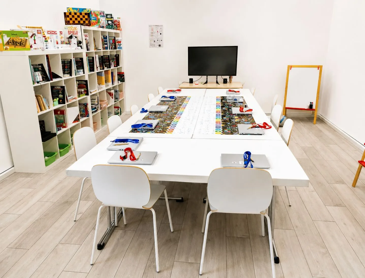 the Swiss NewEra classroom, laptops and games ready on the table